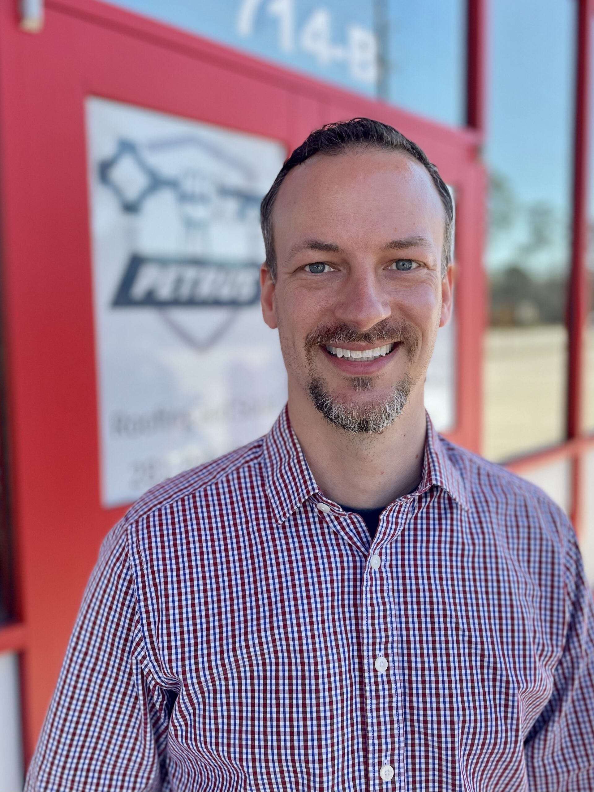 Keaton Lambert, the Admiral, smiling in front of the store